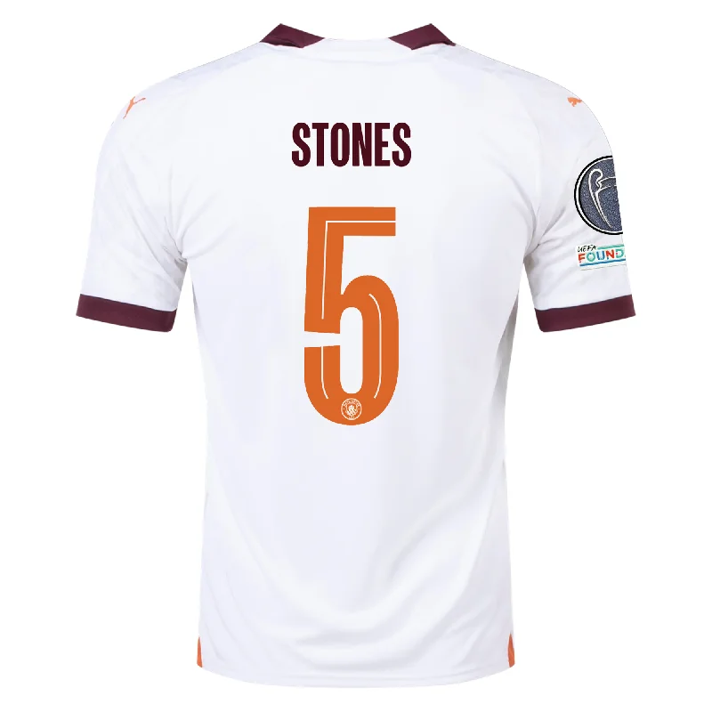 Puma Manchester City John Stones Away Jersey w/ Champions League Patches 23/24 (Puma White/Aubergine) Bold Men's Statement Puma Manchester City John Stones Away Jersey w/ Champions League Patches 23/24 (Puma White/Aubergine) Bold Men's Statement