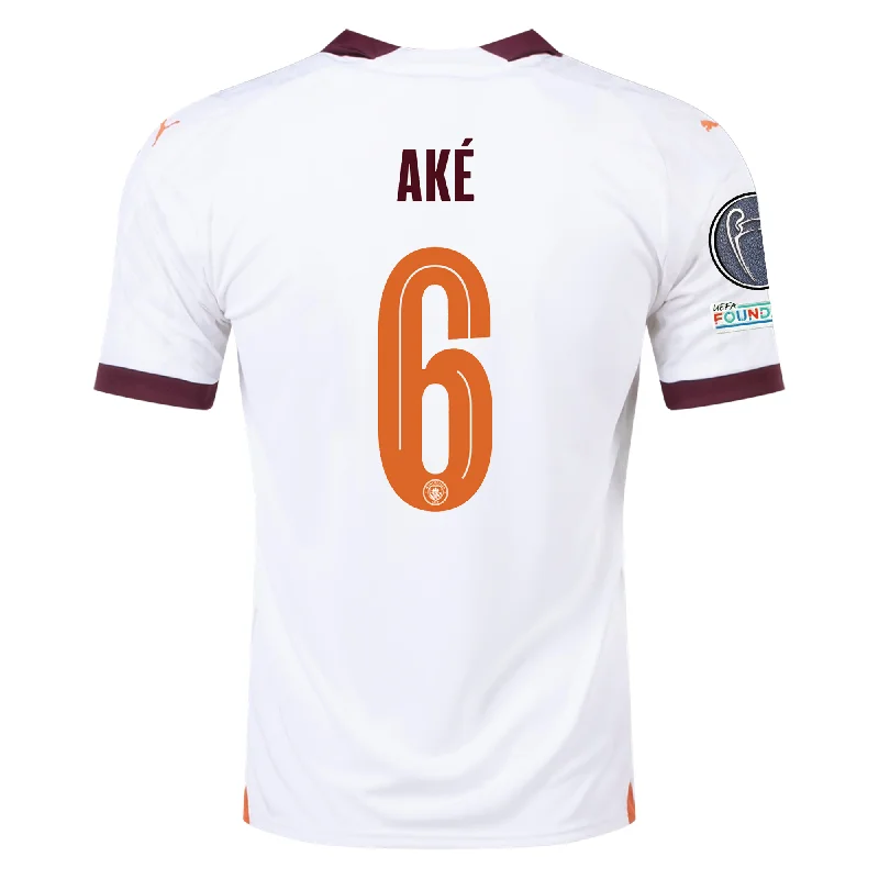 Puma Manchester City Nathan Ake Away Jersey w/ Champions League Patches 23/24 (Puma White/Aubergine) Stylish Men's Tropical Puma Manchester City Nathan Ake Away Jersey w/ Champions League Patches 23/24 (Puma White/Aubergine) Stylish Men's Tropical